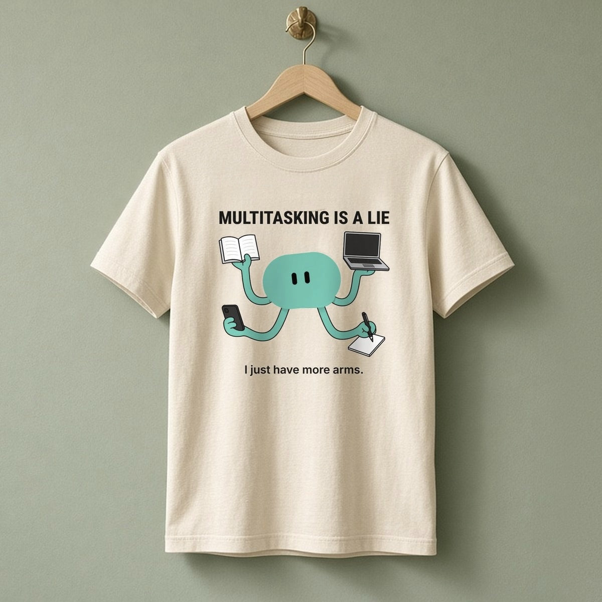 Multitasking Tee – Natural, teal design at mid-chest on a hanger